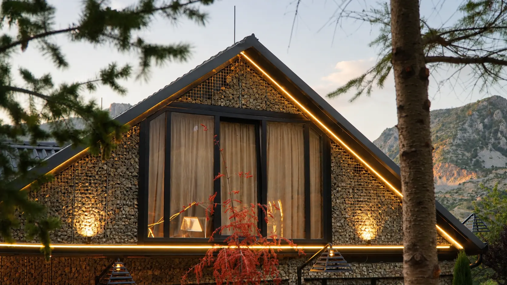 Stone gable with warm lighting and mountains behind