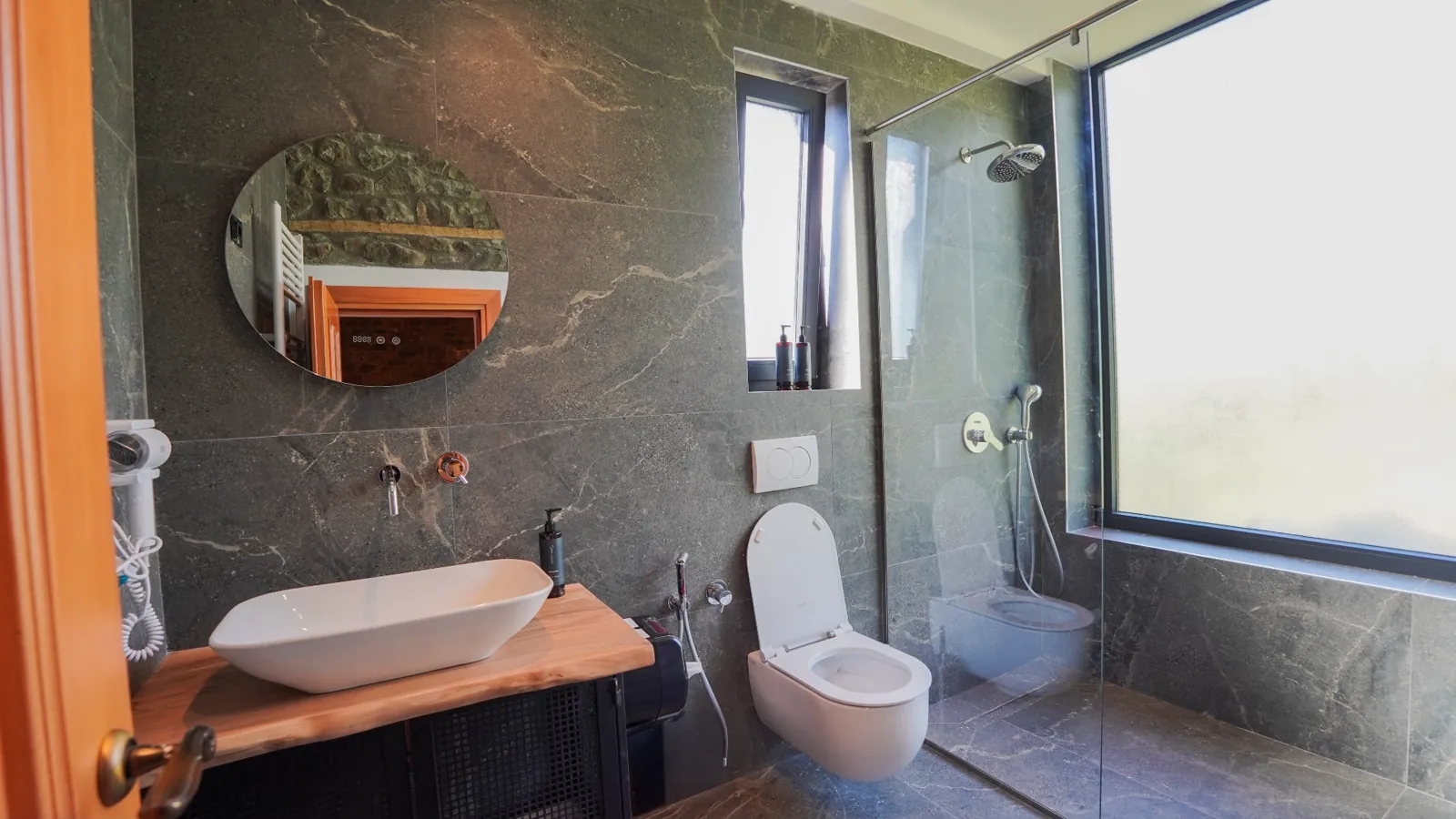 En-suite bathroom with a walk-in shower and wood vanity