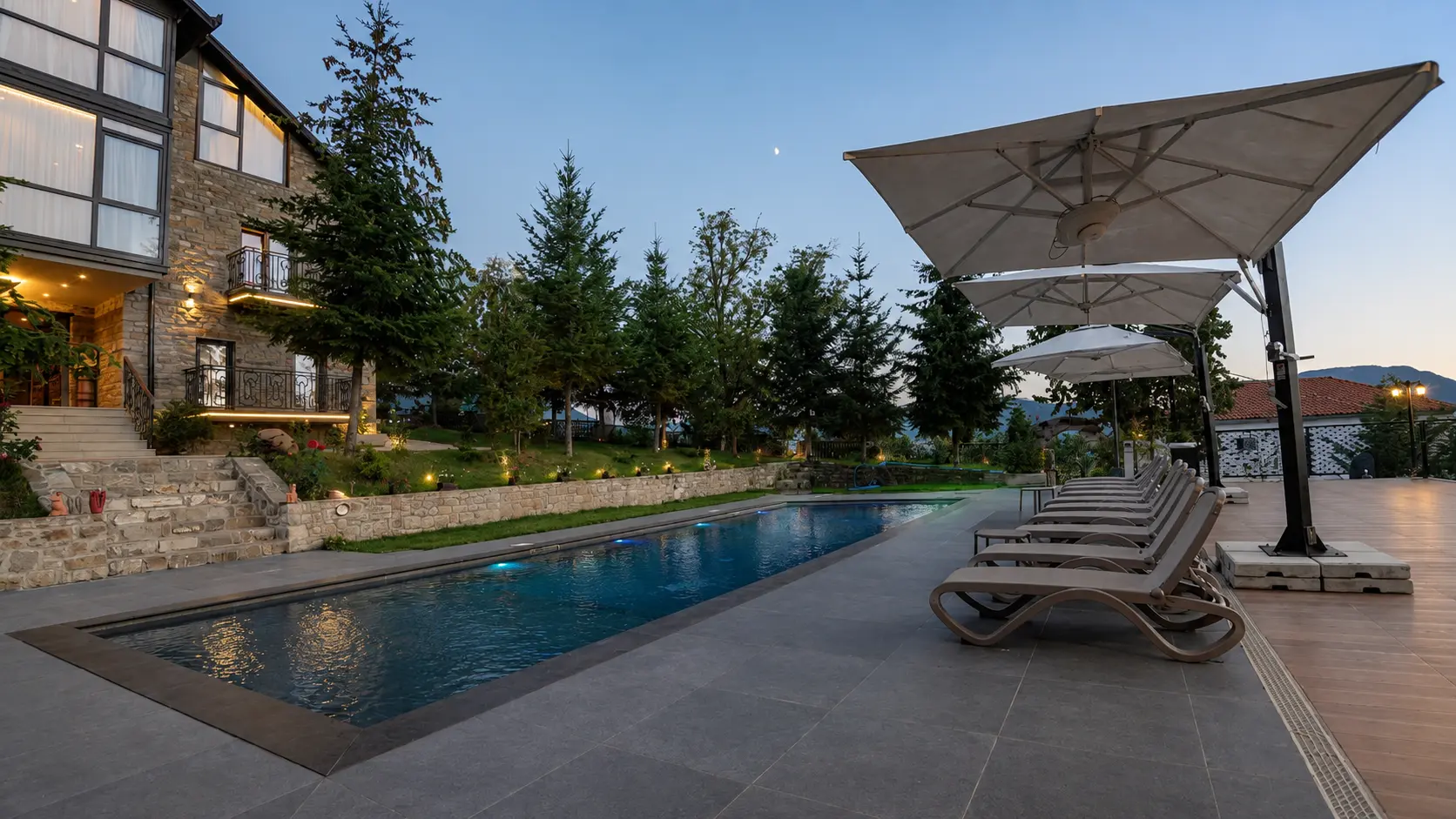 Long pool with sun loungers and umbrellas